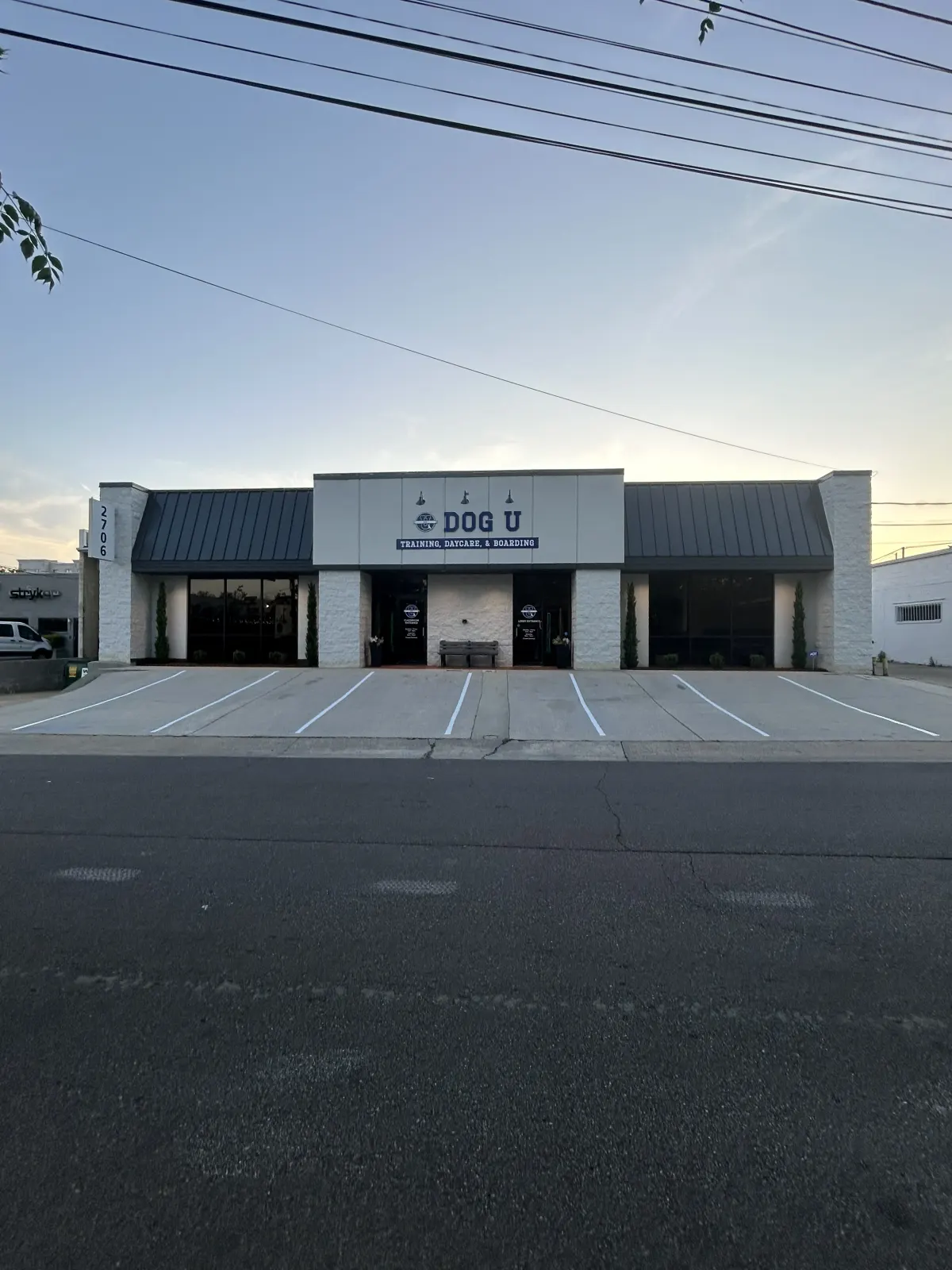 Storefront parking with freshly striped angled stalls at dusk