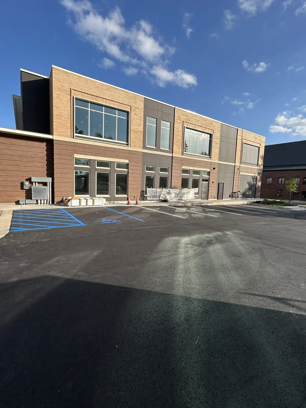 Blue ADA-compliant accessible stalls striped by BAR Striping at a commercial building