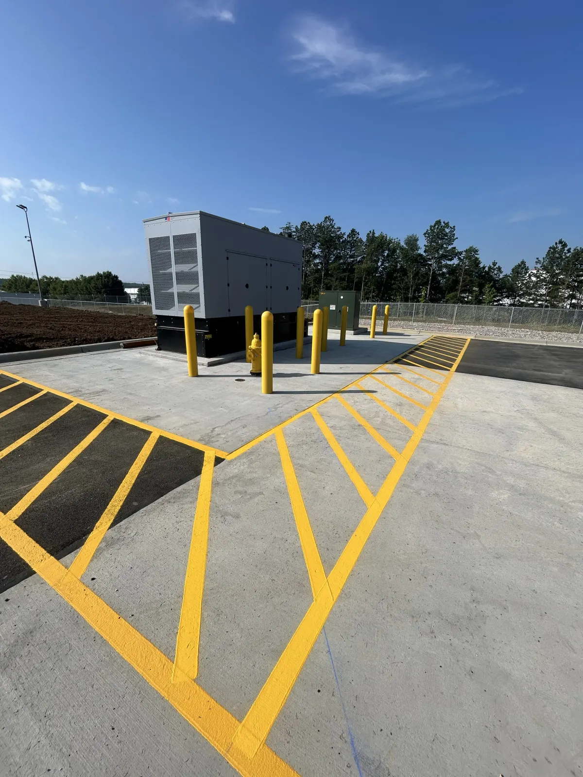 Yellow hatched no-parking zone around an industrial generator pad